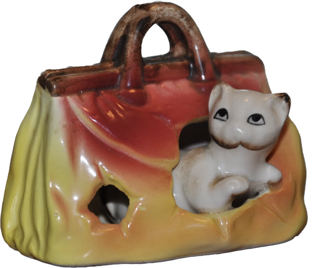 a porcelain statuette of a little weasel sticking out the side of a purse