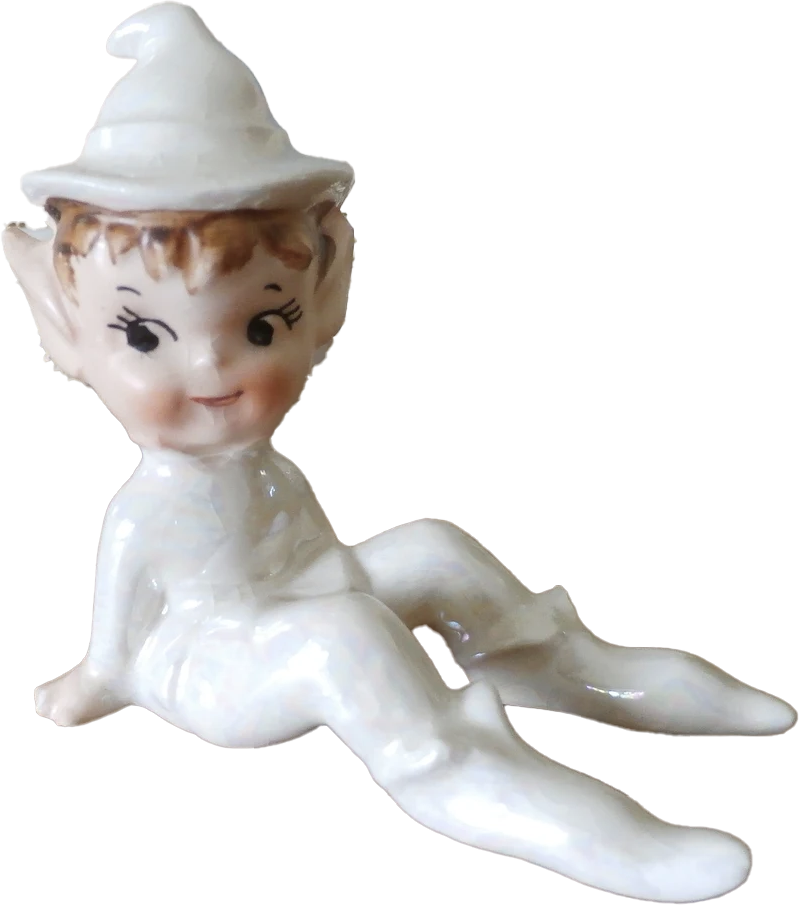 a porcelain statuette of a sitting elf dressed in white