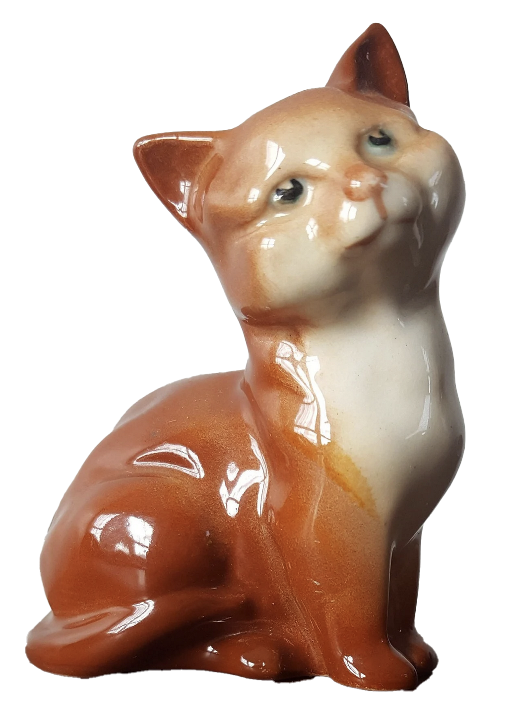 a porcelain statuette of a cat with burnt orange colored fur