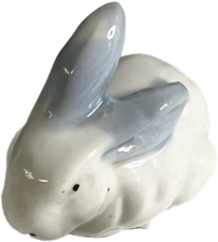 a porcelain statuette of a white bunny with grey ears