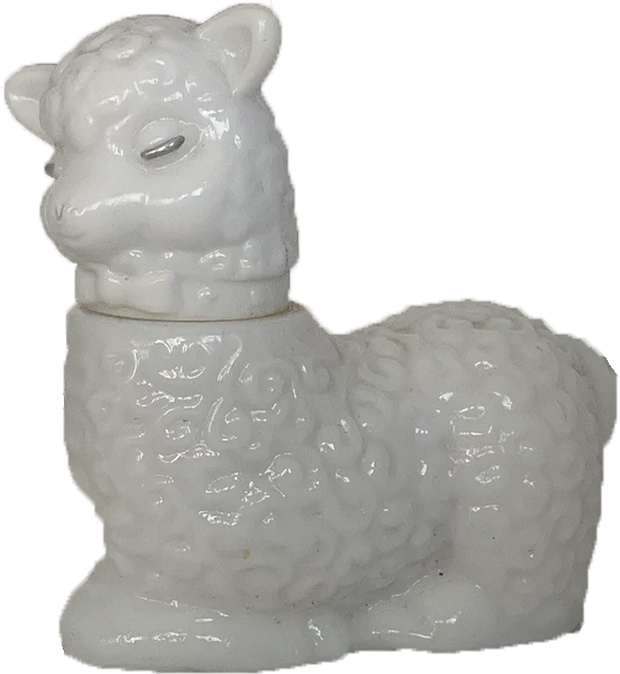 a two piece porcelain statuette of a sleeping sheep