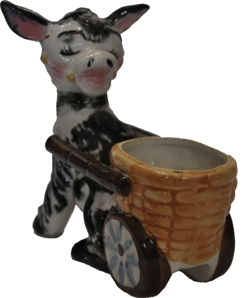 a porcelain statuette of a poney pushing a wheelbarrel