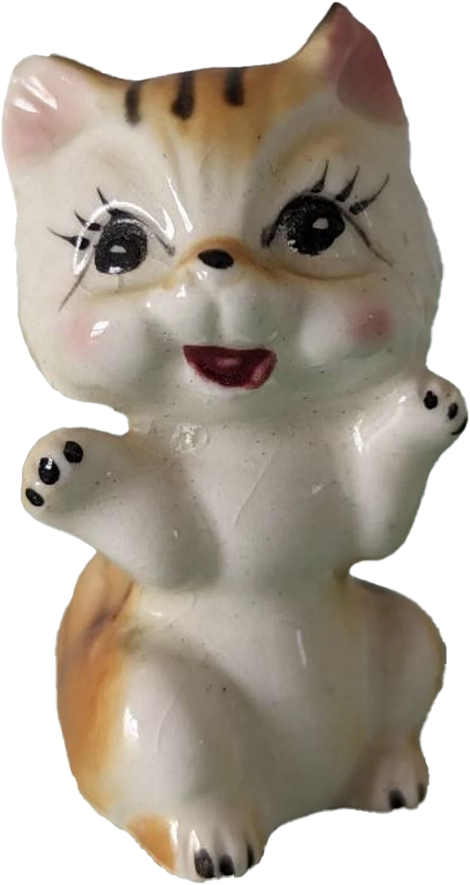 a porcelain statuette of an orange cat standing on its legs with its arms up