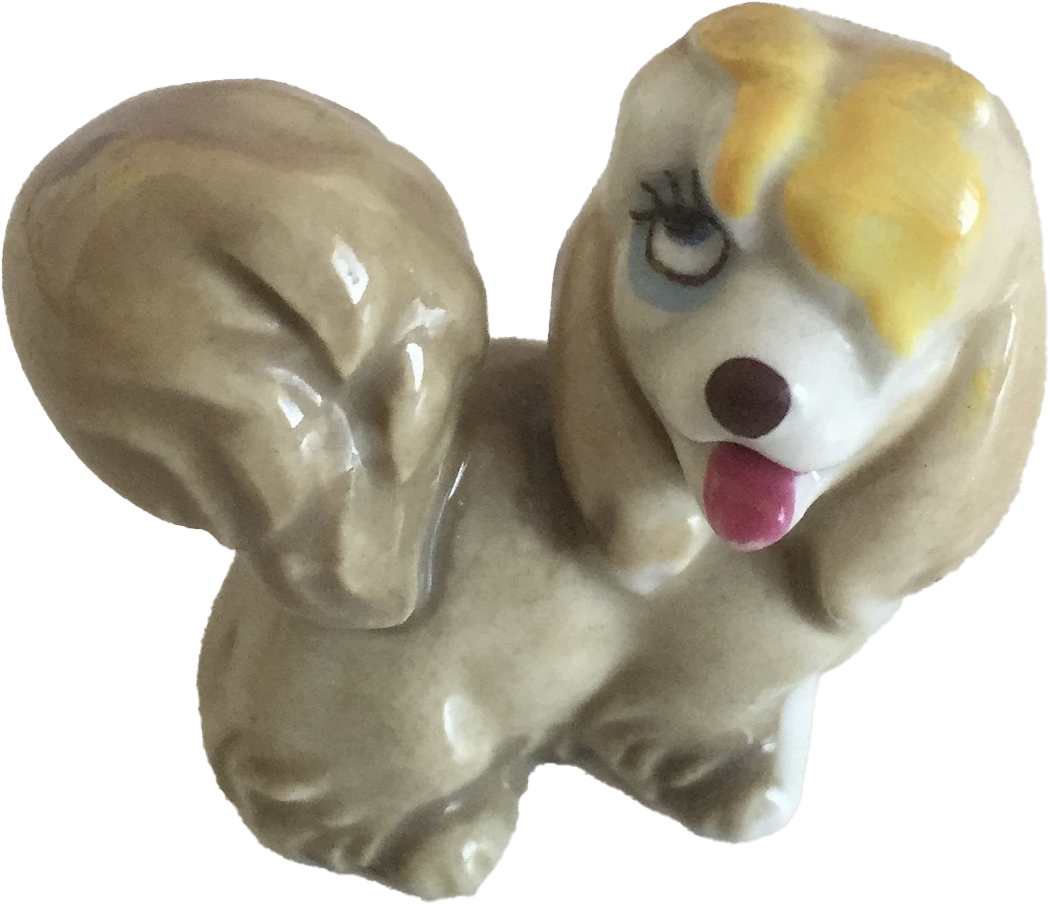 a porcelain statuette of a dog with her tongue out